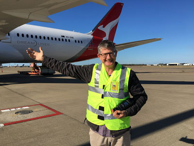 Owner Ewen Macpherson in front of Qantas Dreamliner